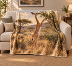 Long-necked gerenuk browsing a leafy shrub on its hind legs before dry woodland printed on a fleece throw blanket
