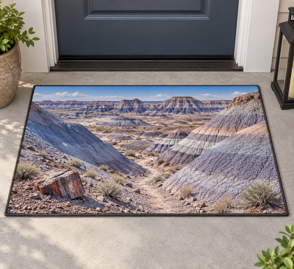 Banded badland hills with a petrified log and receding trail printed on a complete rectangular bound doormat at a doorway