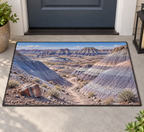 Banded badland hills with a petrified log and receding trail printed on a complete rectangular bound doormat at a doorway