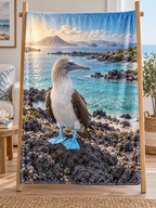 Blue-footed booby on lava before a deep turquoise coast printed on a complete fleece blanket