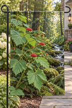 Red thimbleberry fruits beside a deep mossy woodland stream printed on a complete hemmed garden flag