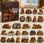 Abyssinian Cat advent calendar box and 24 illustrated acrylic charms displayed on an ivory tabletop in a winter setting