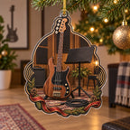 Walnut bass guitar christmas ornament with coiled cable, plain music stand and warm home studio backdrop.
