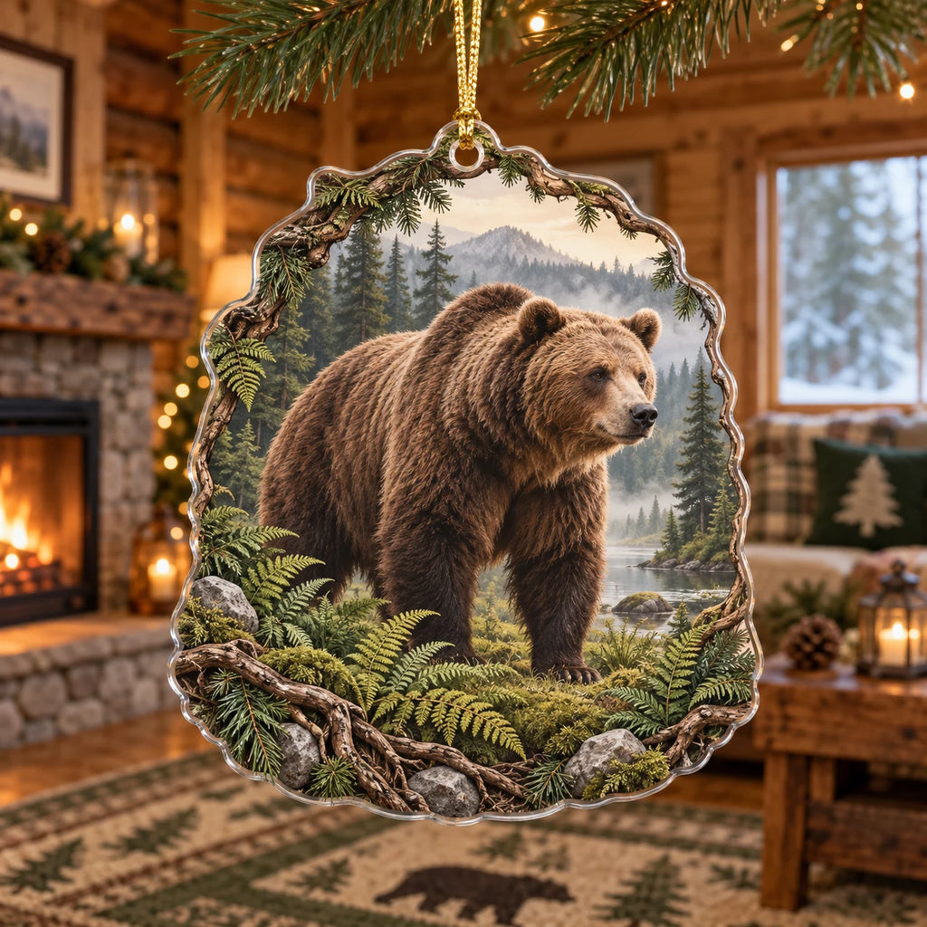 Brown bear christmas ornament with ferns, forest water and misty mountains in a rustic lodge setting.