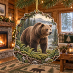 Brown bear christmas ornament with ferns, forest water and misty mountains in a rustic lodge setting.