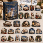 Cornish Rex advent calendar box and 24 illustrated acrylic charms displayed on an ivory tabletop in a winter setting