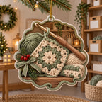 Full acrylic ornament with supported gold cord, yarn-loop border, crochet square, single hook and evergreen ribbon detail.