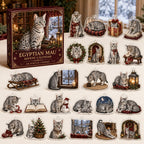 Egyptian Mau advent calendar box and 24 illustrated acrylic charms displayed on an ivory tabletop in a winter setting