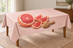 Grapefruit Citrus Prep Tablecloth with printed pink grapefruit segments and wooden reamer depth