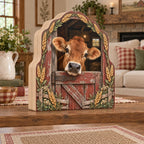 Jersey cow wooden block with brown cow peeking over red barn door, wheat accents and coordinated farmhouse setting.