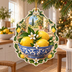Flat acrylic ornament showing lemons in a blue-white bowl, citrus blossom frame and gold hanging cord.