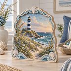 Three-layer wooden block with lighthouse, dune flowers and shell-and-wave border in a coastal setting.