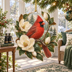 Northern Cardinal acrylic Christmas ornament framed by cream magnolias and green leaves