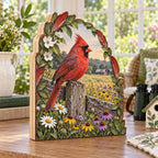 Three-layer wooden block showing a Northern Cardinal on a weathered fence above white, yellow and purple meadow flowers.
