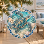 Christmas Ornament featuring a sea turtle with four flippers, scallop shells, pearl illustrations and teal waves.
