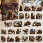 Sussex Spaniel advent calendar box and 24 illustrated acrylic charms displayed on an ivory tabletop in a winter setting